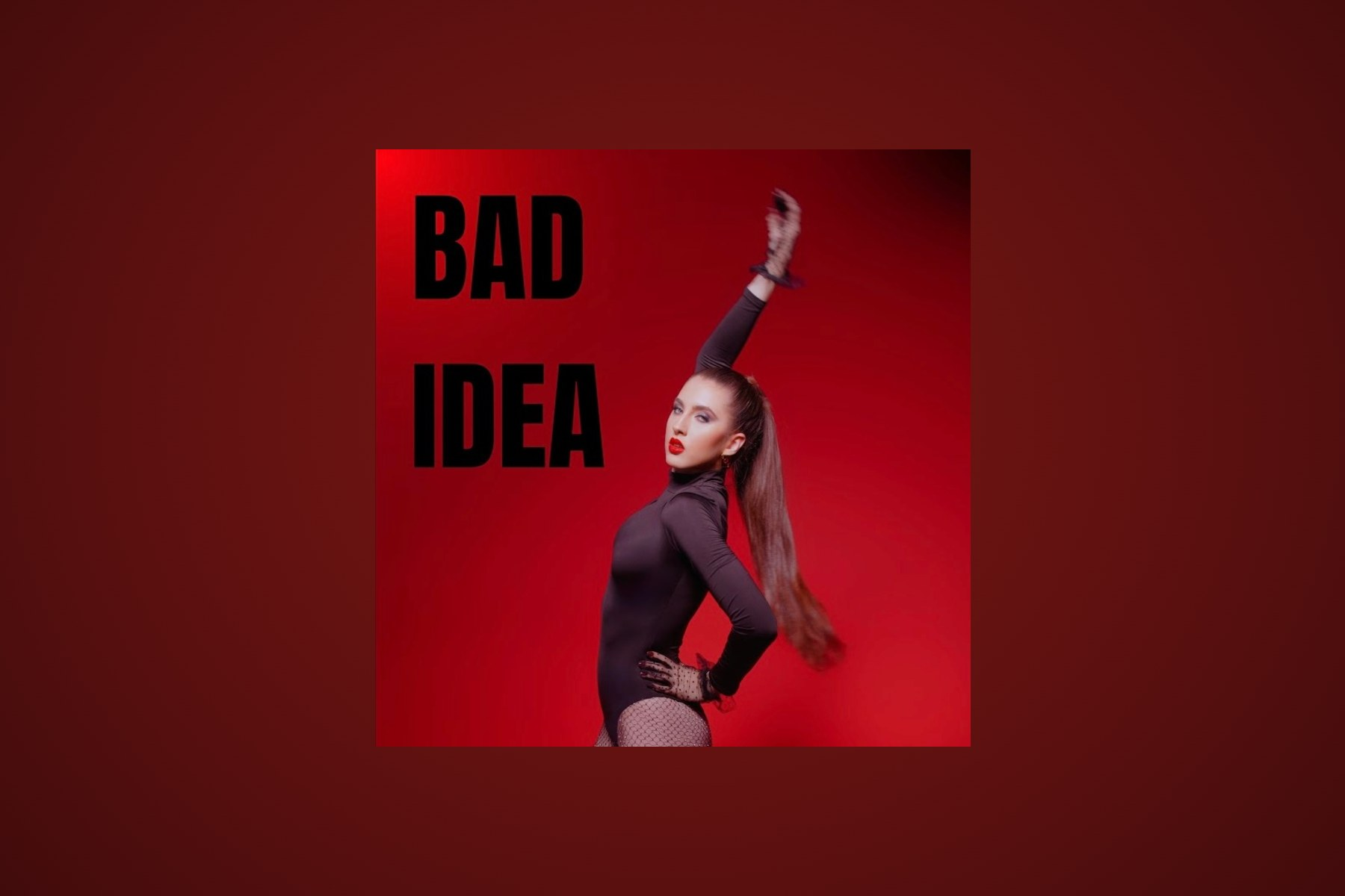 Natalia Soborski on the cover art for her single BAD IDEA, one arm raised, in a black bodysuit and opera gloves against a deep red backdrop.