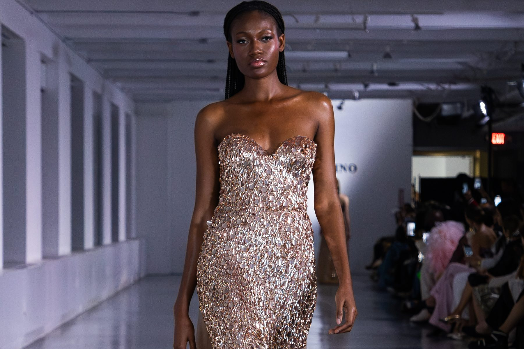 A model in a gold beaded Oliver Tolentino gown on the Gilded Dreams runway at New York Fashion Week