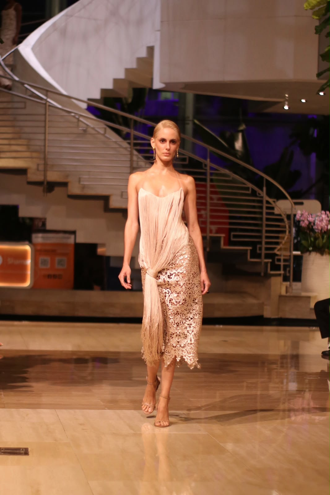 A model wears a blush fringed halter top over a lace midi skirt from SKAPA Atelier’s Spring/Summer 2027 collection, Behind the Lace.